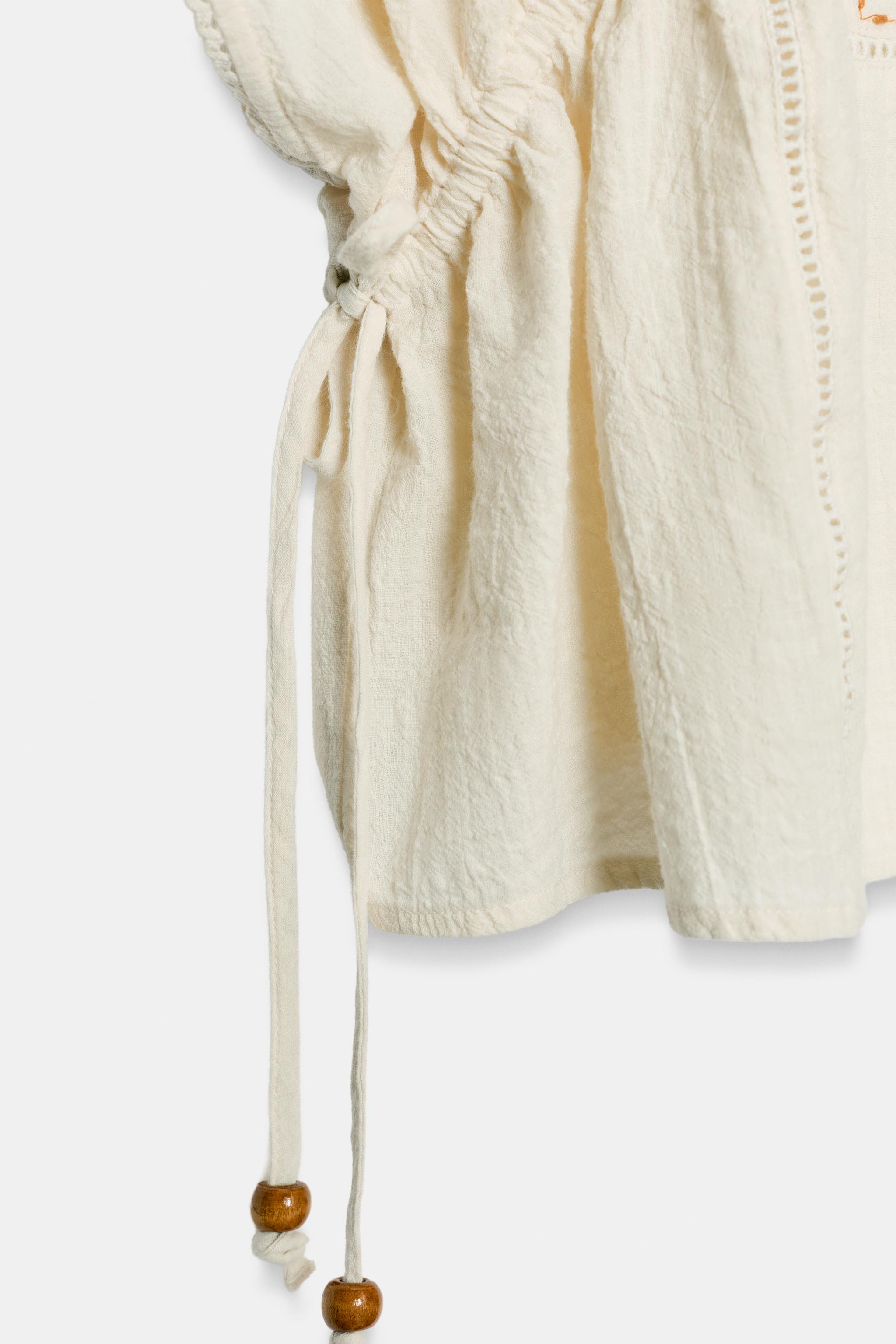EMBROIDERED TOP WITH SIDE LACING